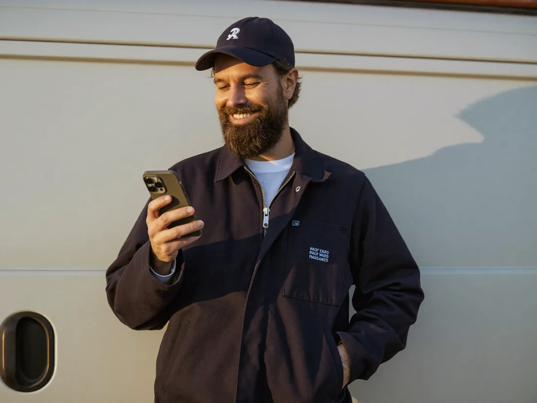 A small business owner relaxed because an AI agent is answering his phone