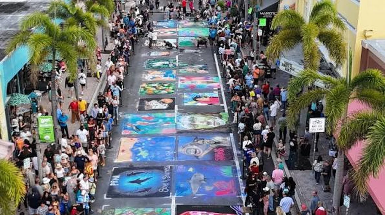 The Street Painting Festival filling Lake Avenue with chalk artworks and crowds in downtown Lake Worth Beach, Florida