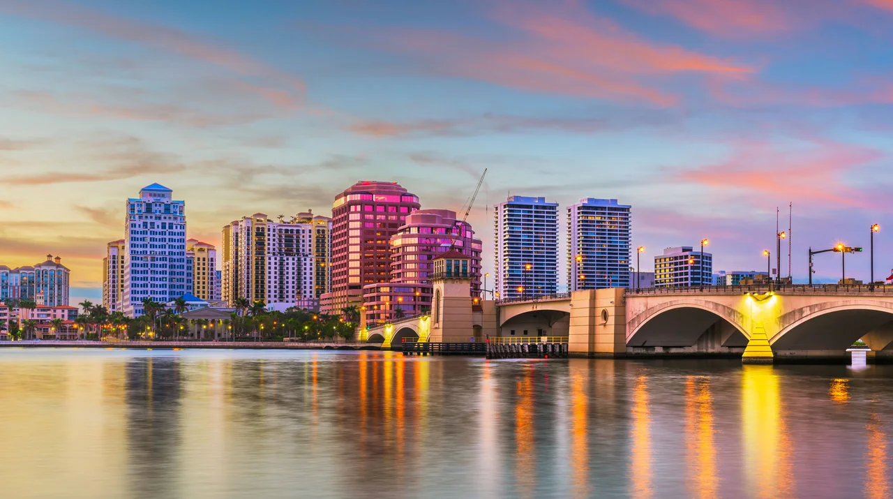 The West Palm Beach, Florida skyline at sunset across the Intracoastal, with the Royal Park Bridge lit alongside